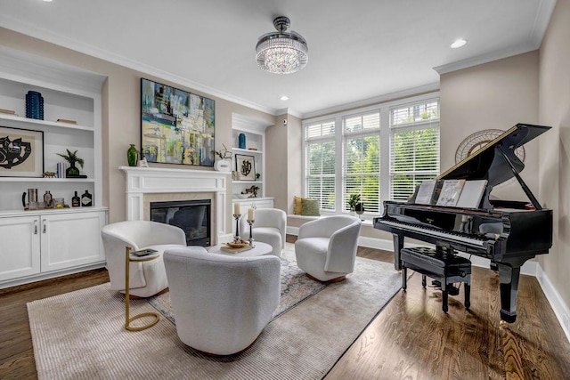 1120 Cordia Ave NW, Atlanta, GA 30318 - living area featuring crown molding, a glass covered fireplace, built in shelves, wood finished floors, and baseboards