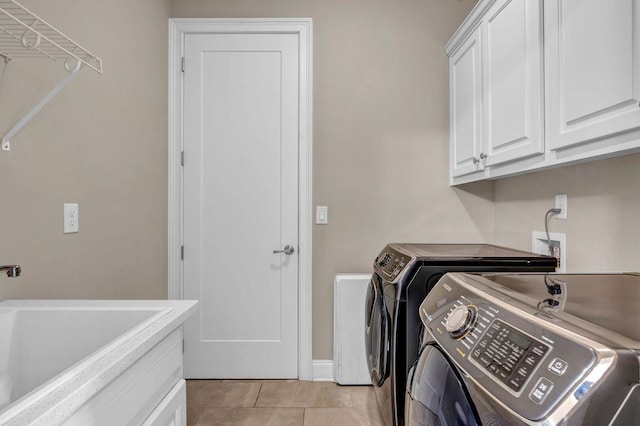 1120 Cordia Ave NW, Atlanta, GA 30318 - laundry room with washer and dryer, cabinet space, light tile patterned floors, and baseboards