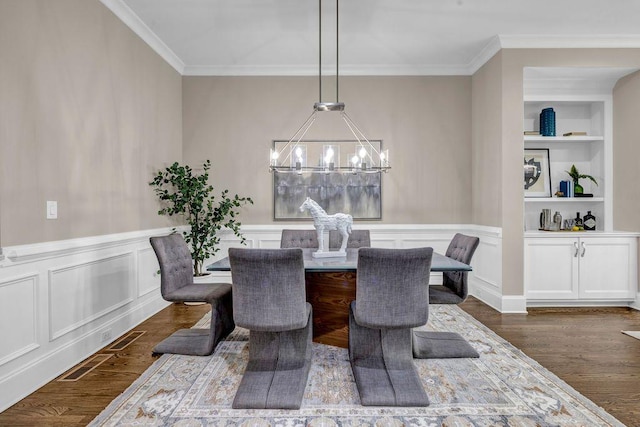1120 Cordia Ave NW, Atlanta, GA 30318 - dining space featuring a chandelier, ornamental molding, dark wood-style floors, breakfast area, and built in shelves