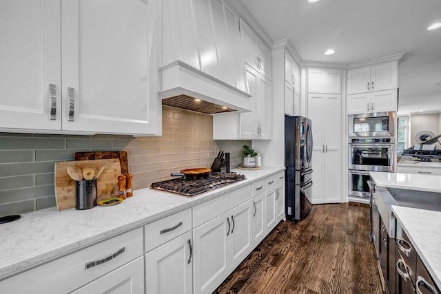 1120 Cordia Ave NW, Atlanta, GA 30318 - kitchen featuring stainless steel appliances, premium range hood, dark wood-type flooring, white cabinets, and recessed lighting