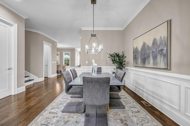 1120 Cordia Ave NW, Atlanta, GA 30318 - dining area with ornamental molding, dark wood-type flooring, a chandelier, stairs, and wainscoting