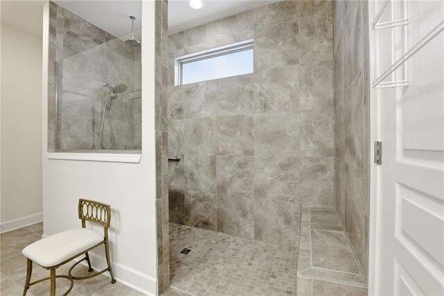 bathroom featuring walk in shower and baseboards