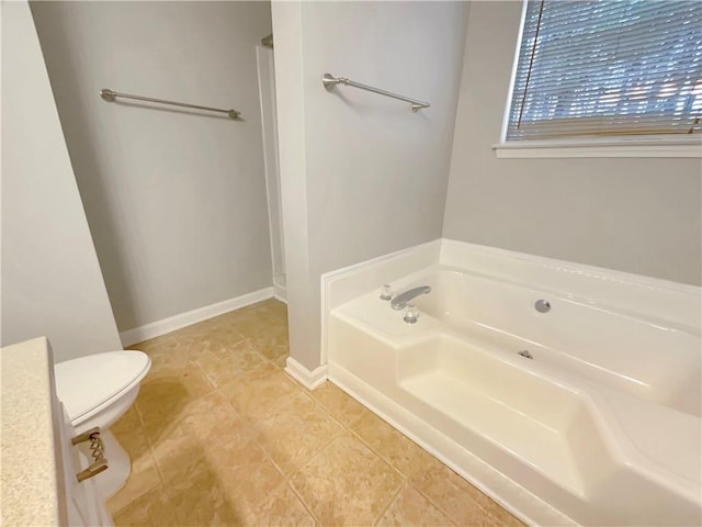 bathroom featuring a bathing tub, toilet, and tile patterned floors