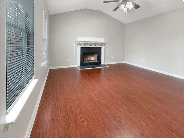 unfurnished living room with dark hardwood / wood-style floors, vaulted ceiling, and ceiling fan