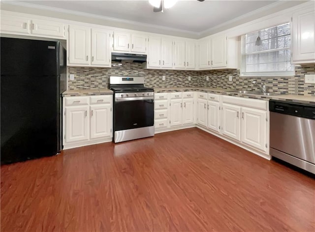 kitchen with backsplash, sink, white cabinets, and stainless steel appliances