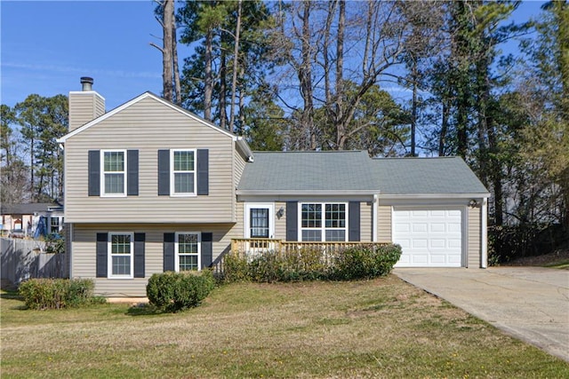 split level home featuring a garage, driveway, a chimney, and a front yard