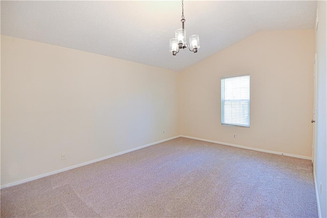 empty room with lofted ceiling, light carpet, baseboards, and an inviting chandelier