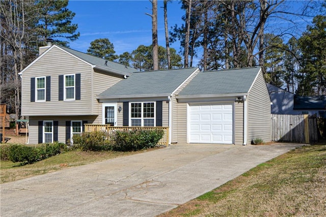 split level home featuring a garage, driveway, and a chimney