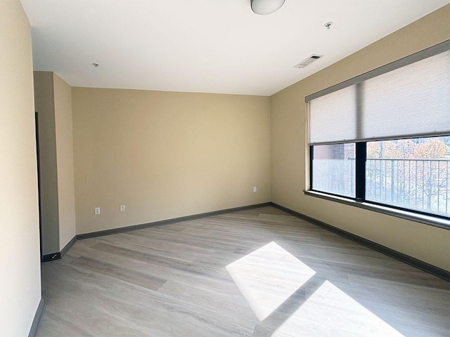 empty room with light hardwood / wood-style flooring