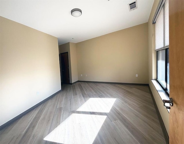 spare room with light hardwood / wood-style floors