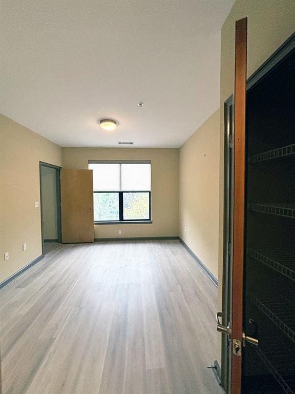 unfurnished room with light hardwood / wood-style flooring