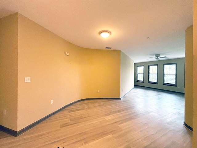 empty room featuring hardwood / wood-style flooring and ceiling fan