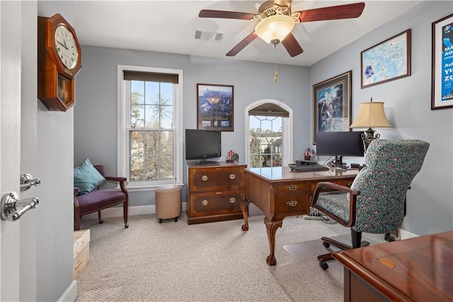 carpeted office space featuring ceiling fan and a wealth of natural light