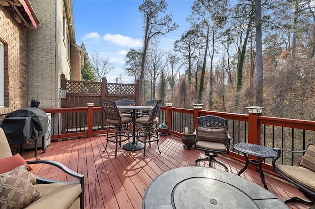 wooden terrace with area for grilling