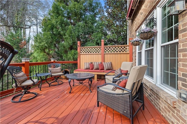 wooden deck with an outdoor living space