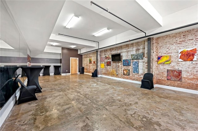 interior space with brick wall and concrete floors