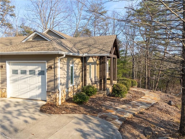 view of home's exterior featuring a garage and covered porch