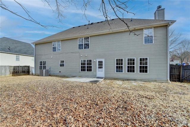 rear view of property with central AC and a patio