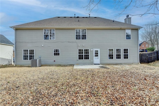 rear view of house featuring central AC unit and a patio area