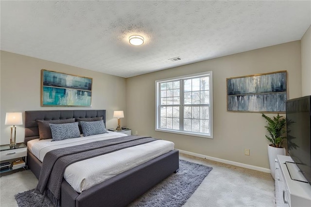 carpeted bedroom with a textured ceiling