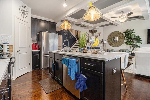 kitchen featuring coffered ceiling, dark wood-style flooring, a breakfast bar area, and stainless steel appliances