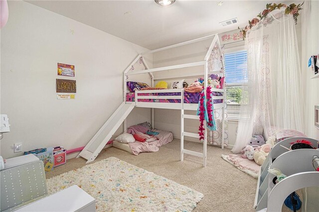 bedroom featuring carpet floors and visible vents