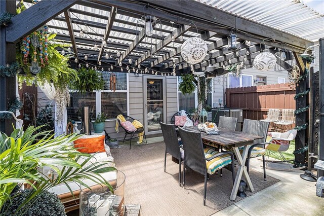 view of patio / terrace featuring outdoor dining area, fence, and a pergola
