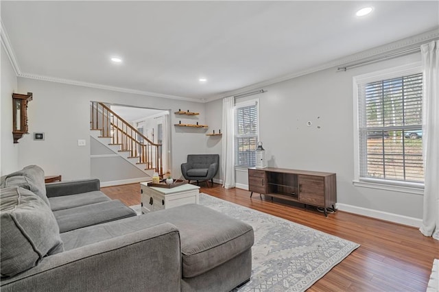 living area with recessed lighting, stairway, ornamental molding, wood finished floors, and baseboards