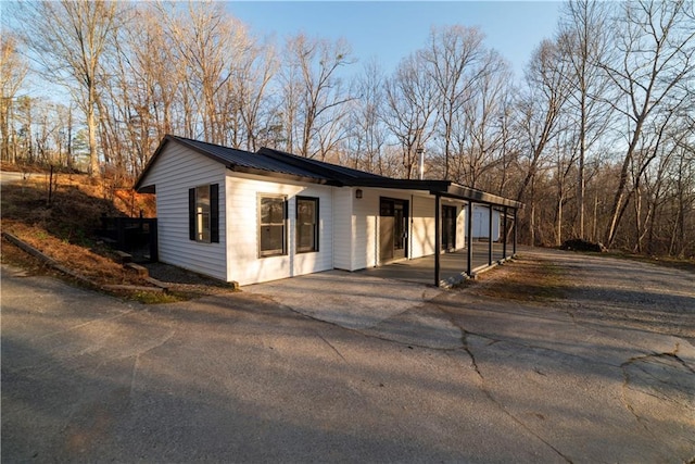 view of front of home featuring aphalt driveway and metal roof