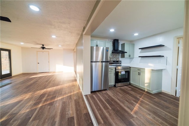 kitchen with dark wood-type flooring, wall chimney range hood, backsplash, and stainless steel appliances