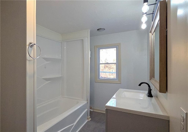 bathroom with vanity, baseboards, and shower / washtub combination