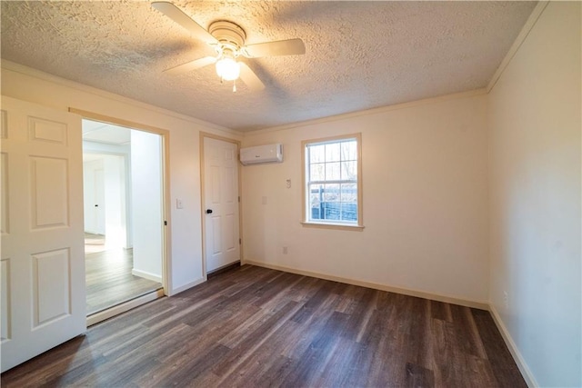 unfurnished bedroom with an AC wall unit, baseboards, dark wood-style flooring, and ornamental molding