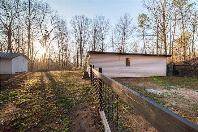 exterior space with an outbuilding and fence