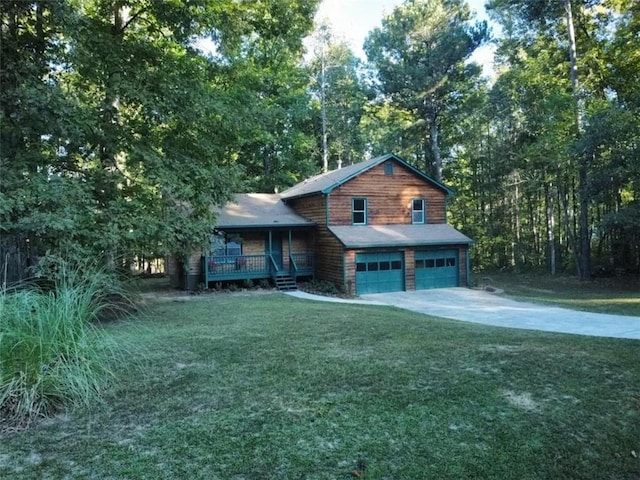 view of front of home with a front lawn, a garage, and a porch