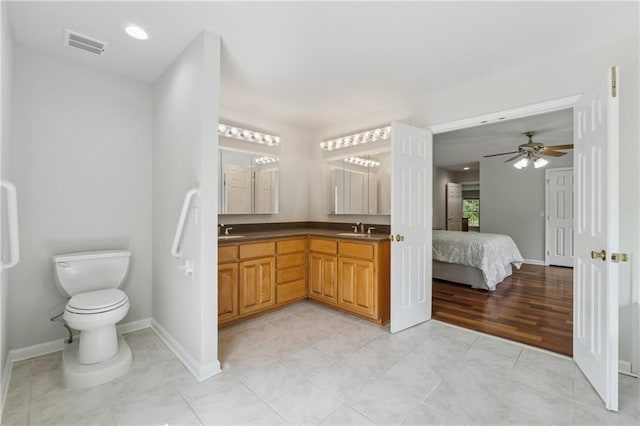 full bathroom with visible vents, a sink, baseboards, and connected bathroom