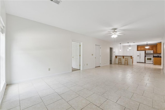 unfurnished living room featuring a ceiling fan, baseboards, visible vents, and light tile patterned floors