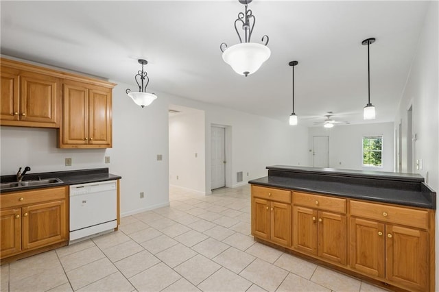 kitchen featuring dark countertops, a sink, and dishwasher