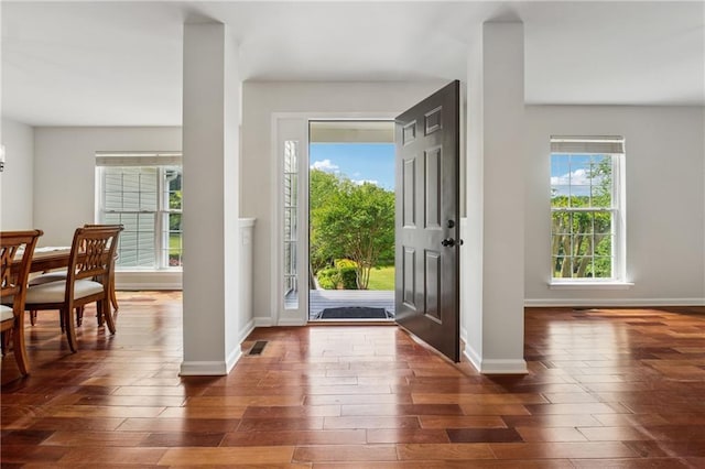 entrance foyer with baseboards and dark wood-style floors