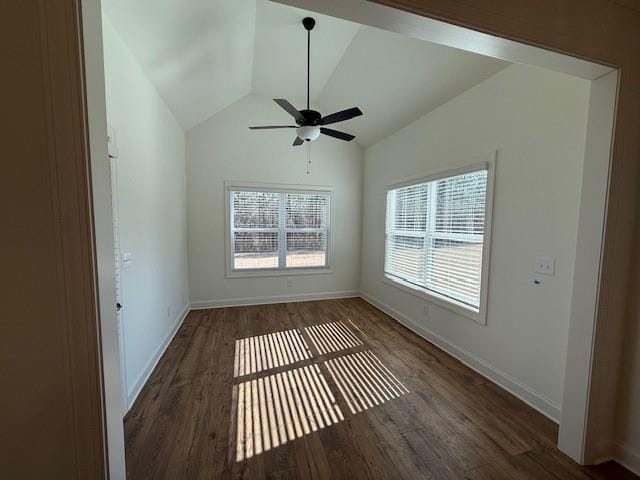 spare room with a ceiling fan, vaulted ceiling, baseboards, and wood finished floors