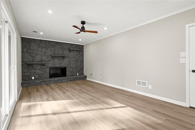 unfurnished living room with visible vents, wood finished floors, ceiling fan, and crown molding