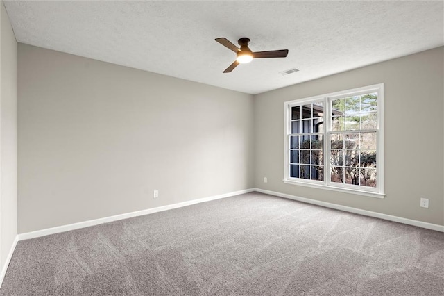 spare room featuring visible vents, carpet flooring, baseboards, and a ceiling fan