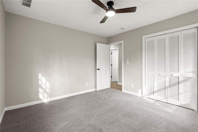 unfurnished bedroom with a ceiling fan, baseboards, visible vents, a closet, and carpet flooring