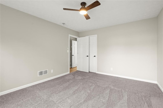 unfurnished bedroom with visible vents, baseboards, ceiling fan, and carpet flooring