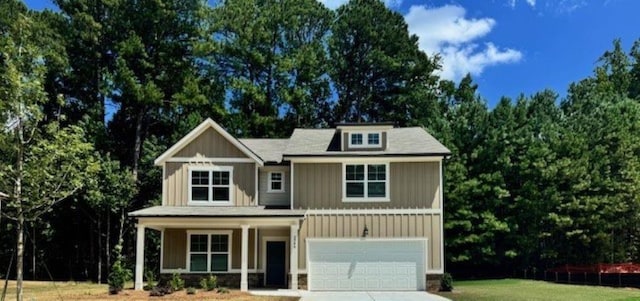 craftsman-style house featuring a garage and a front lawn