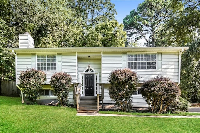 bi-level home with a front lawn