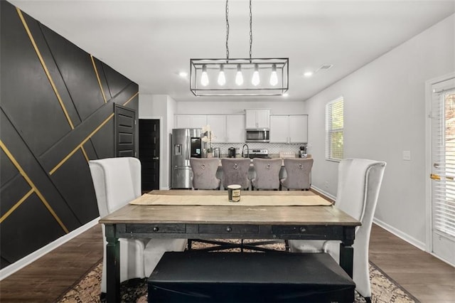 dining room with dark wood-type flooring