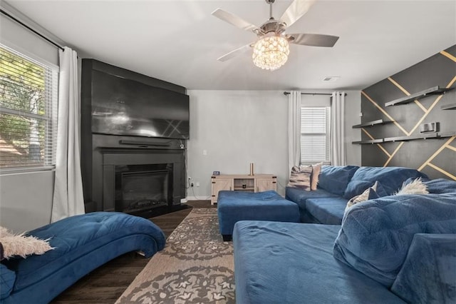 living room featuring dark wood-type flooring and ceiling fan