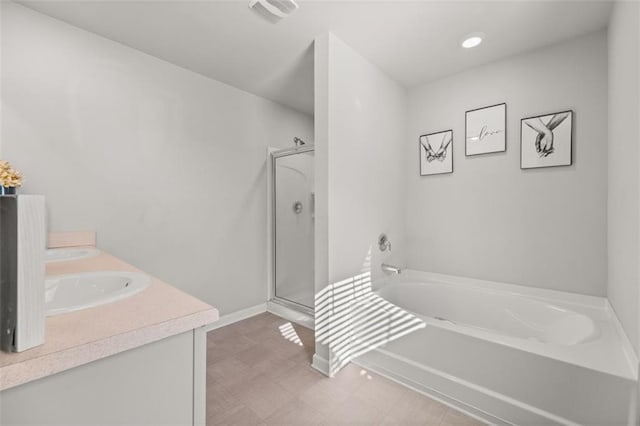 bathroom with vanity and shower with separate bathtub