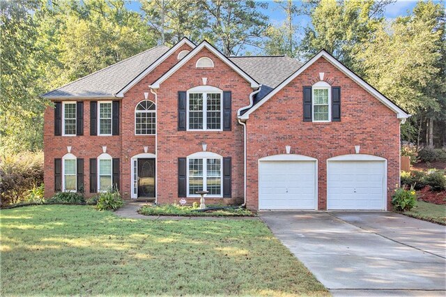 view of front of house featuring a front yard and a garage