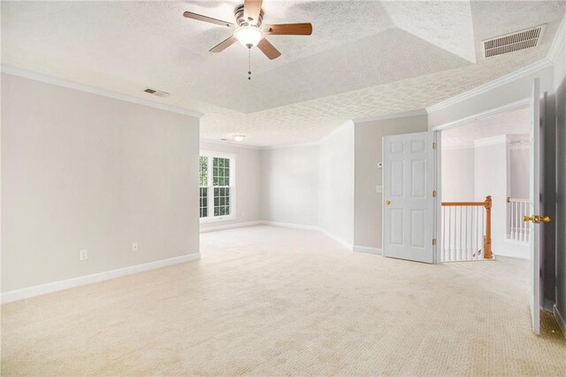 carpeted spare room with crown molding, a textured ceiling, and ceiling fan